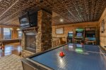 Terrace level game room with double sided fireplace